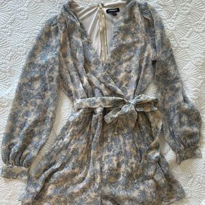 Blue and cream floral romper. Pleating detail and sash.